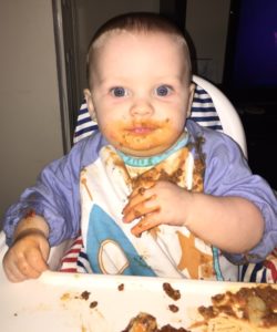 Sonny at 9 months enjoying granny's lasagne