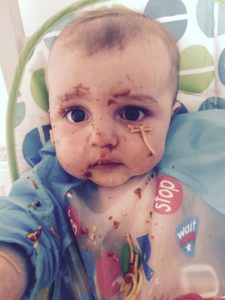 Freddie at 5.5mo enjoying spaghetti bolognaise for the first time