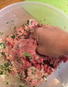 Mixing beef mince, chopped kale and soaked breadcrumbs